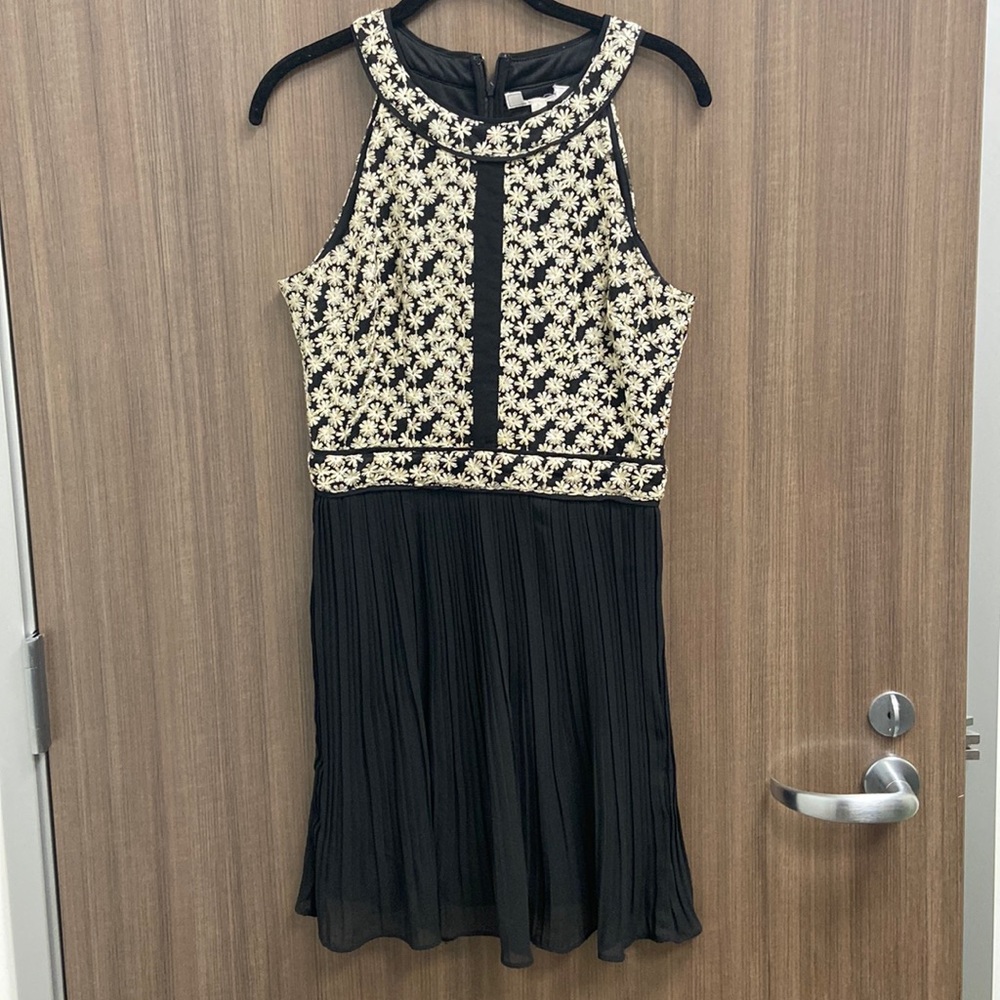 Simple flowing black dress with embroidery floral pattern